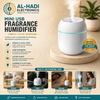 White mini USB fragrance humidifier with cool mist spray and blue LED light ring on a wooden display stand